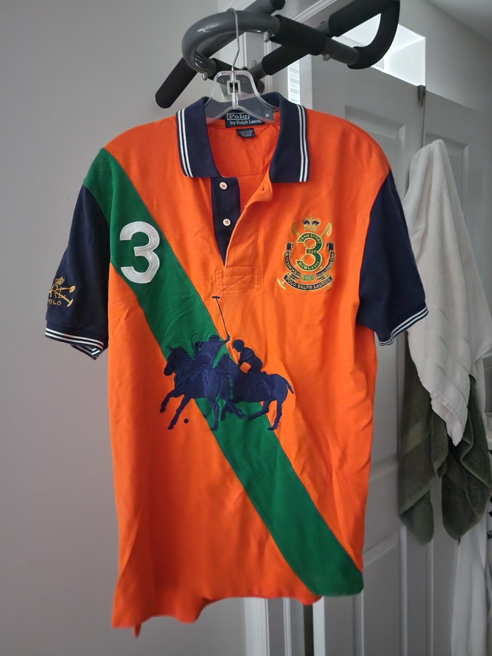 Geographical Norway Orange Polo with Green Diagonal Stripe & Navy Accents.S-M